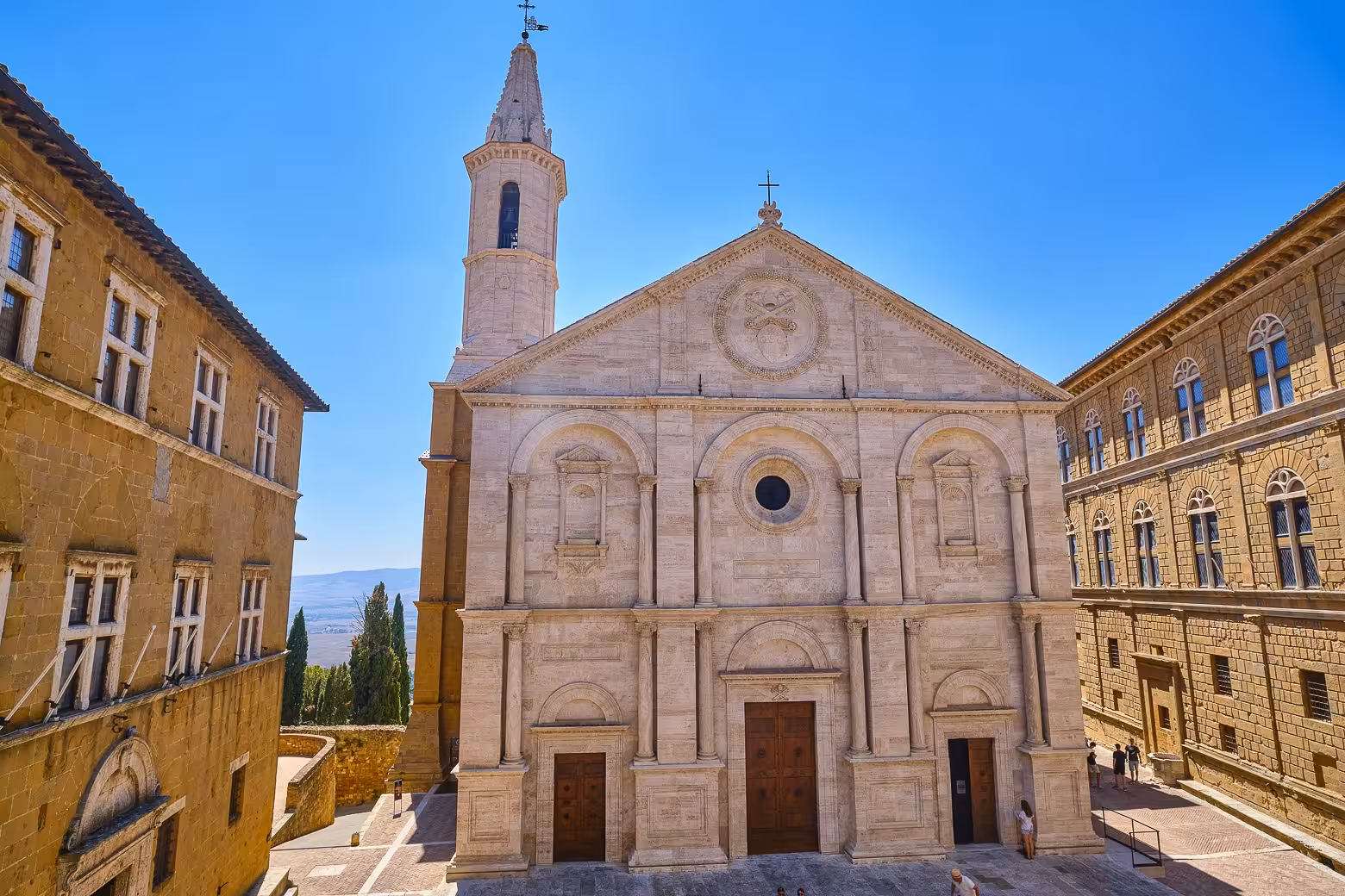 The stunning facade of Pienza Cathedral under a clear blue sky, a highlight on the Land of Brunello tour.