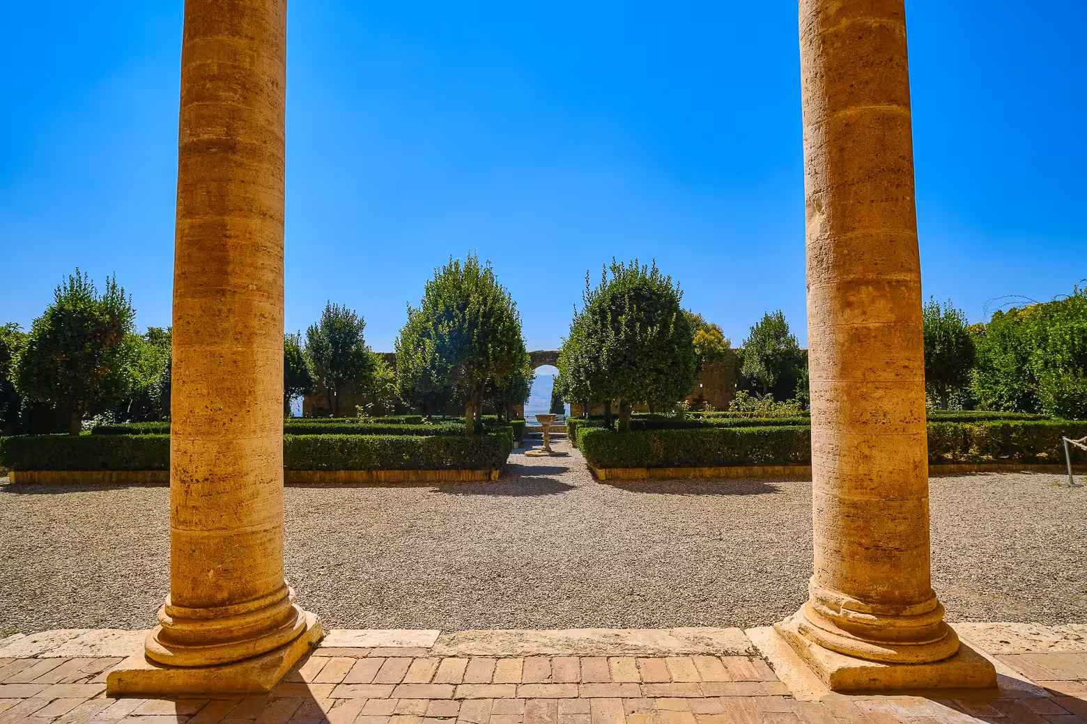 Discover serene gardens framed by columns in Pienza on the Val d'Orcia private tour from Florence.