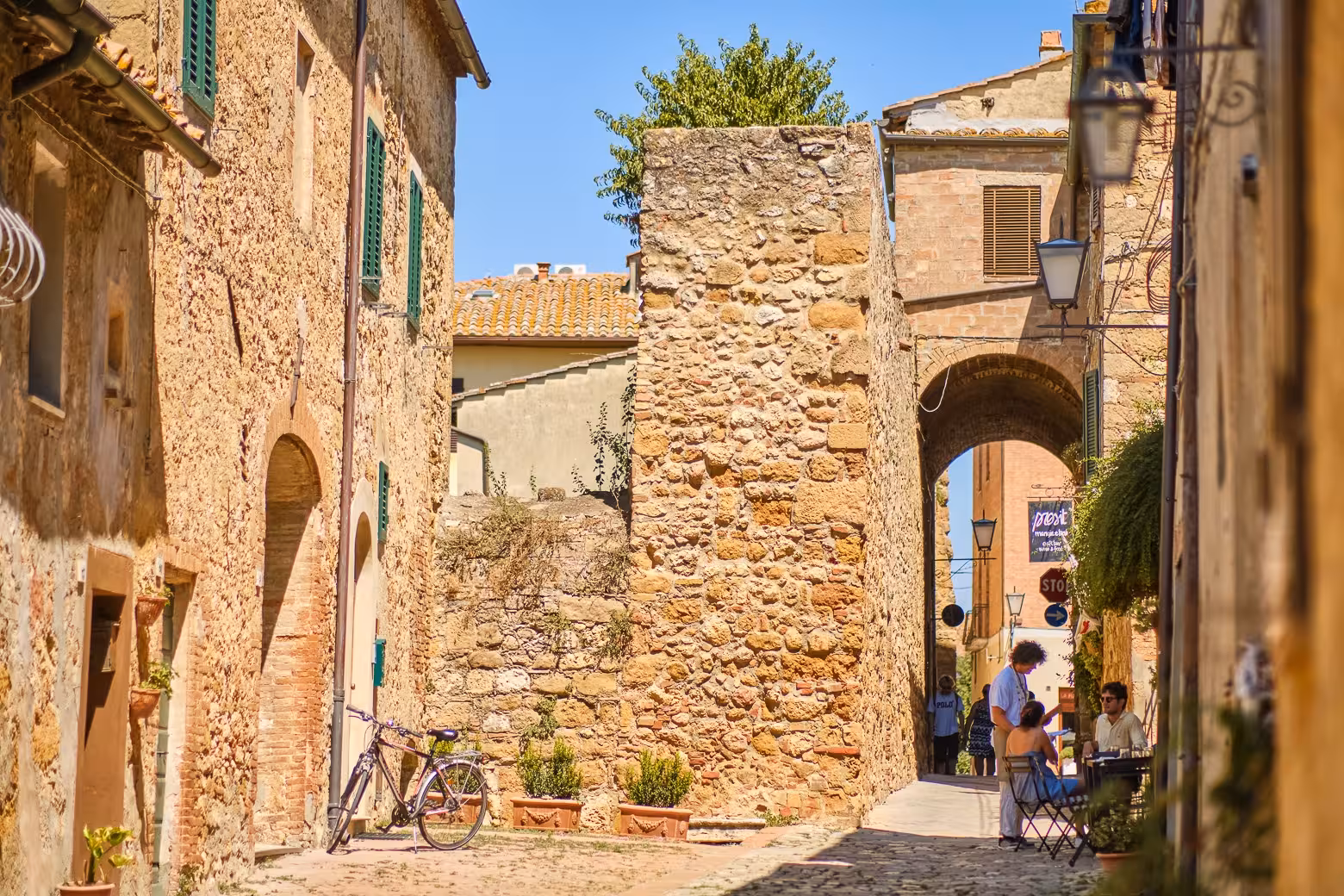 Charming stone alleyway in Pienza, perfect for exploration on the Land of Brunello wine and gourmet tour.