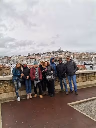 Pilgrims overlooking Marseille harbor and hilltop basilica on a 14-day Christian heritage and Provence tour
