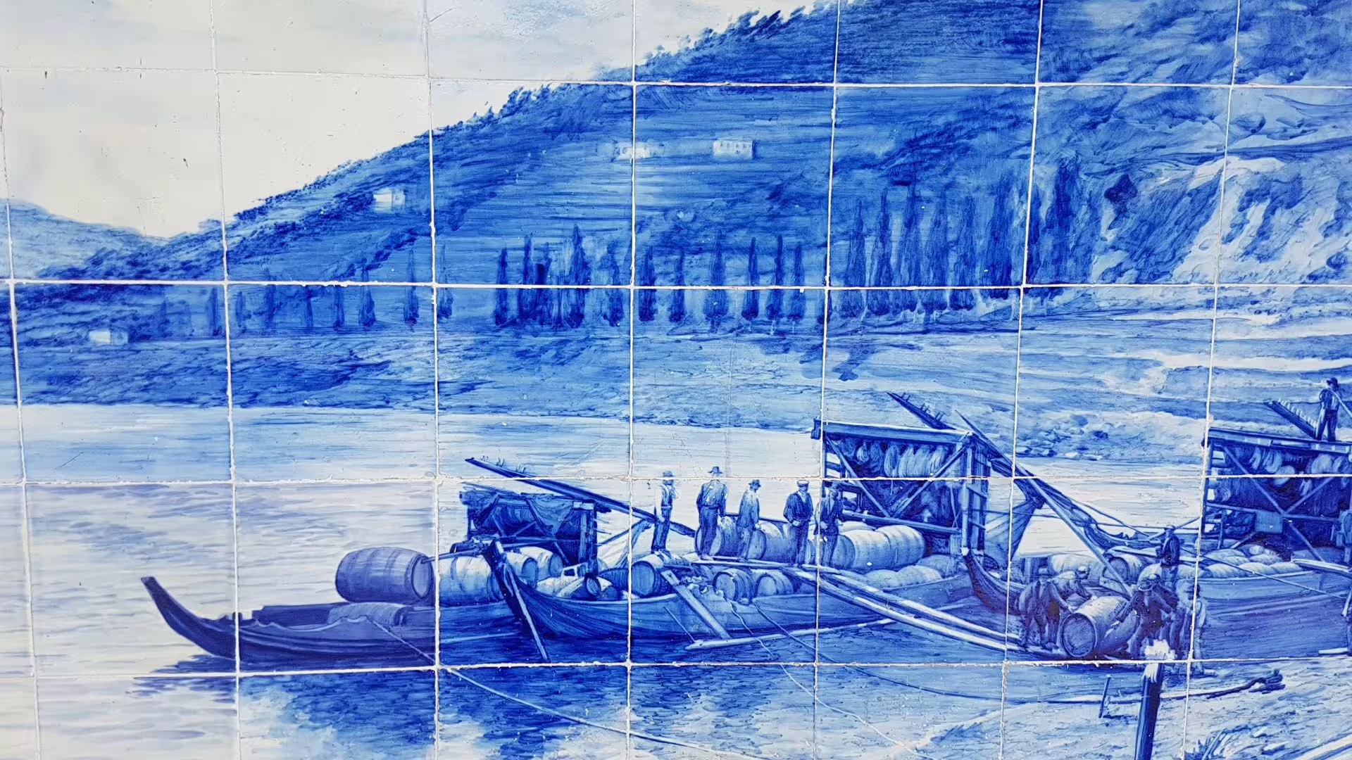 Image of an azulejo or tile panel of Pinhão train station with a Rabelo Boat drawing on Cooltour Oporto's Douro Valley Wine Tour from Porto