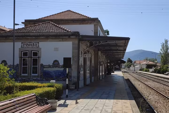 Pinhão train station platform with azulejo tiles and Douro Valley backdrop, a must-see stop on Visit Pinhão