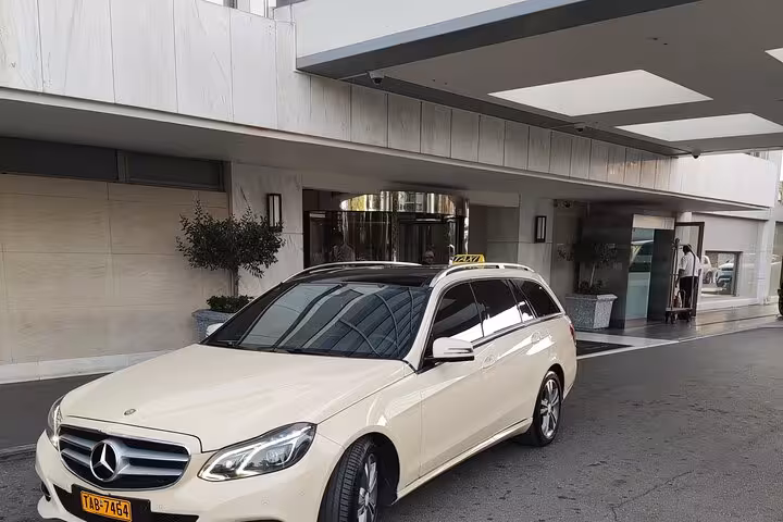 Private Mercedes taxi transfer pickup at Piraeus Port hotel for Athens Airport (ATH) with driver service