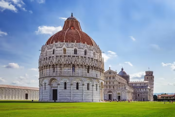 Magnificent view of Pisa's Baptistery and Cathedral under a clear blue sky, ideal for a day trip from Florence.