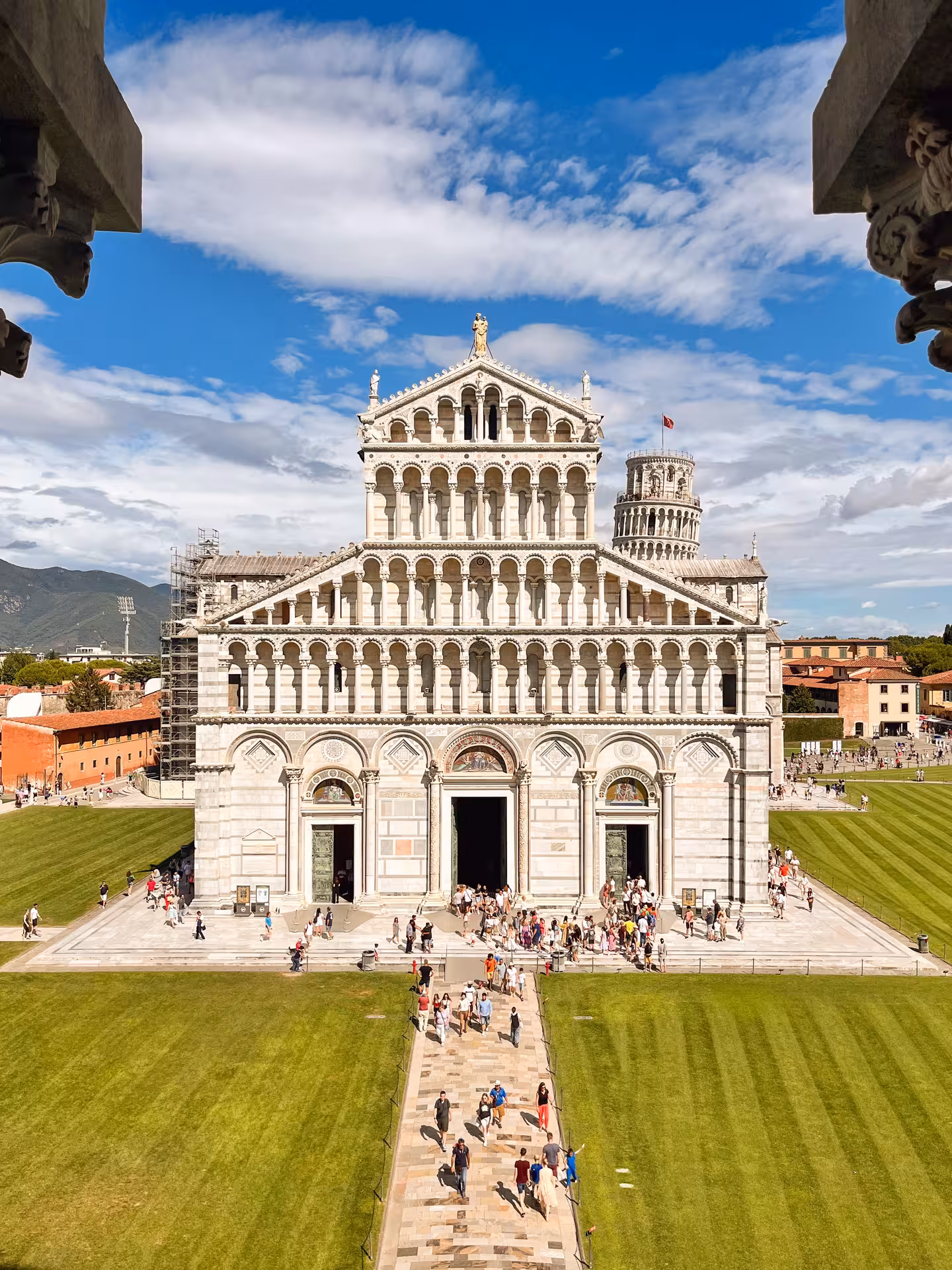 Aerial view of Pisa Cathedral with tourists exploring the historic site on a private tour from Florence.