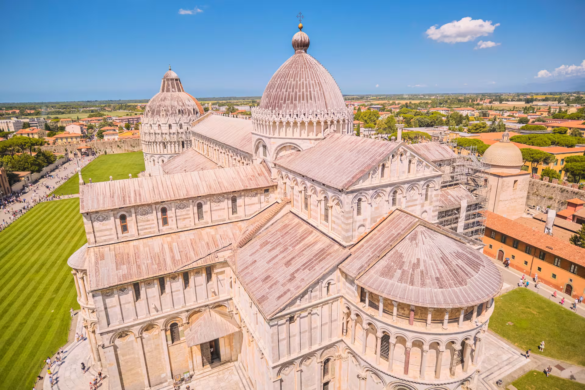 Aerial view of Pisa Cathedral's intricate architecture surrounded by lush greenery on a half-day tour from Florence.