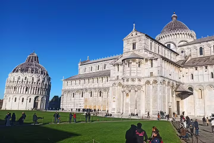 Pisa Cathedral and Baptistery viewed from green lawn on a private Pisa and Lucca excursion with gourmet lunch and wine