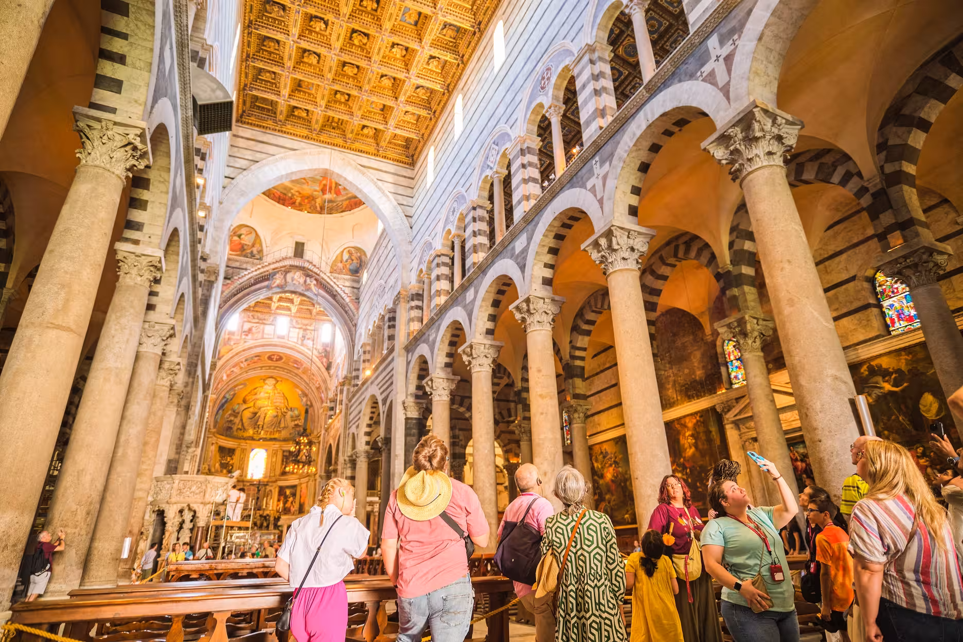 Tourists admire the stunning interiors of Pisa Cathedral during the half-day tour from Florence.