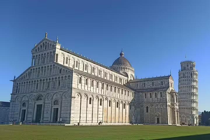 Pisa Cathedral and Leaning Tower under clear blue skies, visited on a private Pisa and Chianti day tour from Tuscany