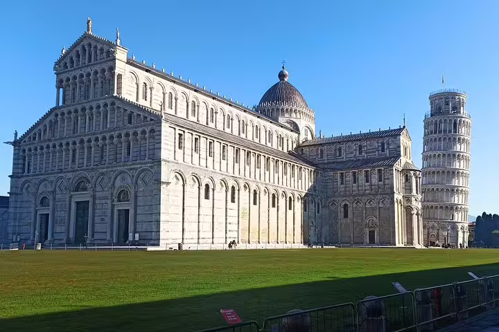 Wide view of Pisa Cathedral and Leaning Tower rising over Piazza dei Miracoli, featured on a private tour from La Spezia cruise port