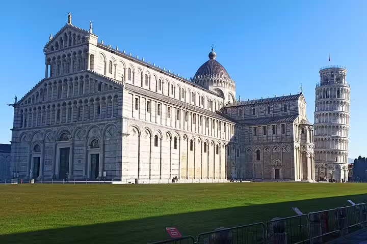 Pisa Cathedral and the Leaning Tower on Piazza dei Miracoli under a clear blue sky during a private Tuscany shore excursion