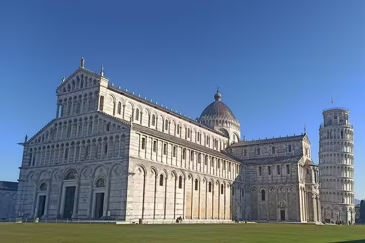 Pisa Cathedral and Leaning Tower under clear blue sky, a highlight of private Pisa and Lucca tour with Tuscan lunch