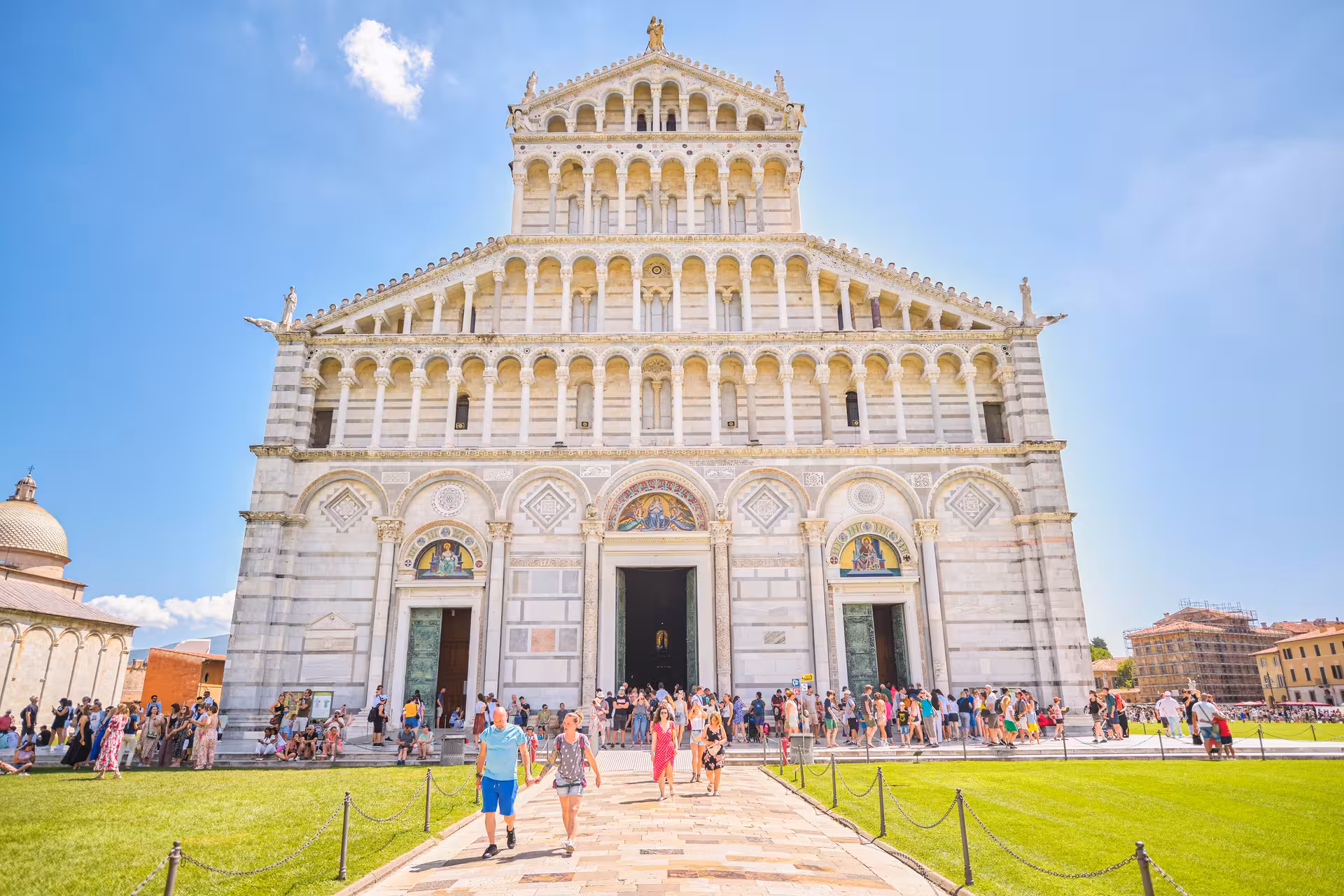 Crowds admire the Pisa Cathedral's intricate façade, a highlight of the Piazza dei Miracoli tour from Florence.