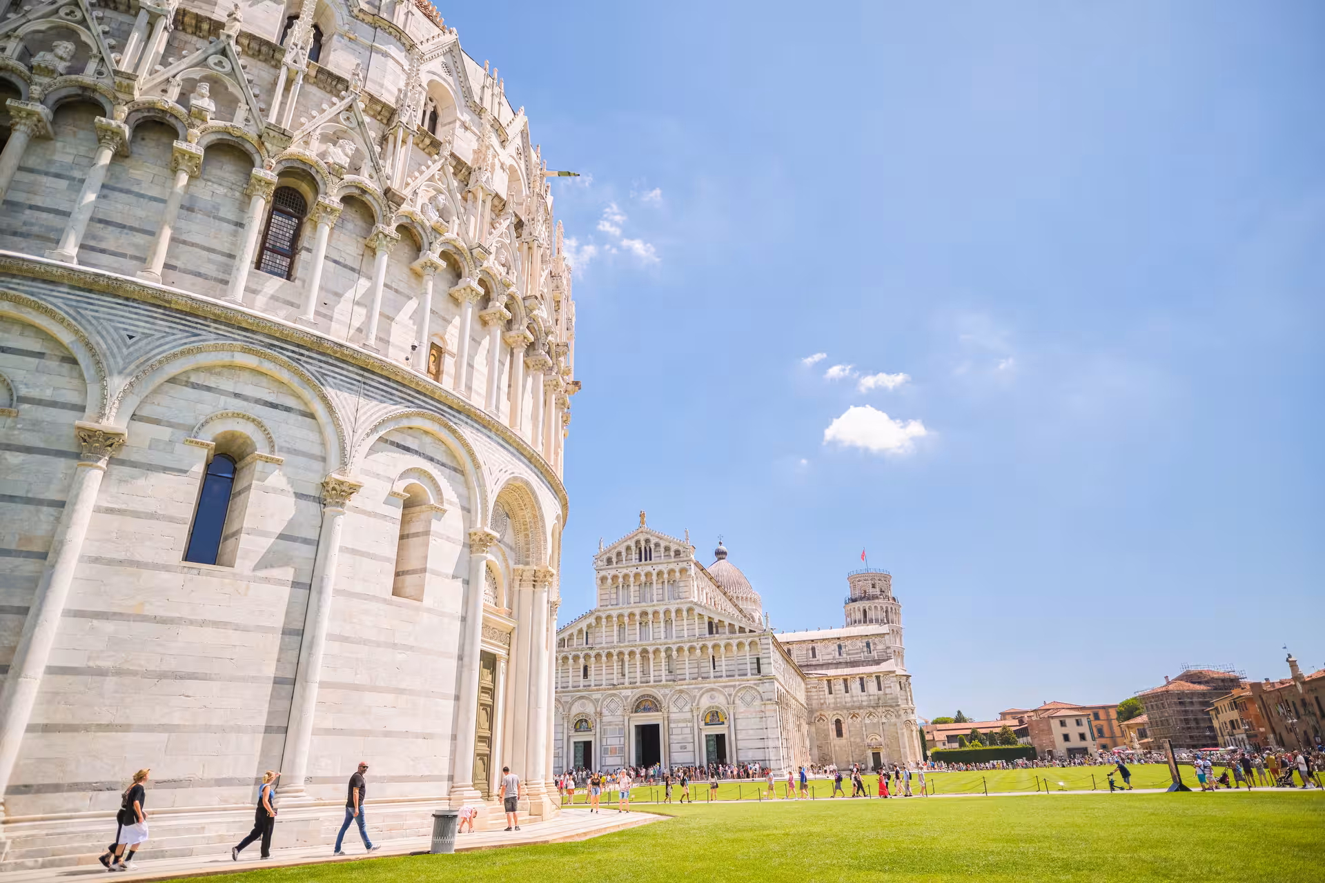 Stunning view of Pisa's Cathedral Square showcasing the Leaning Tower and Baptistery on a sunny day.