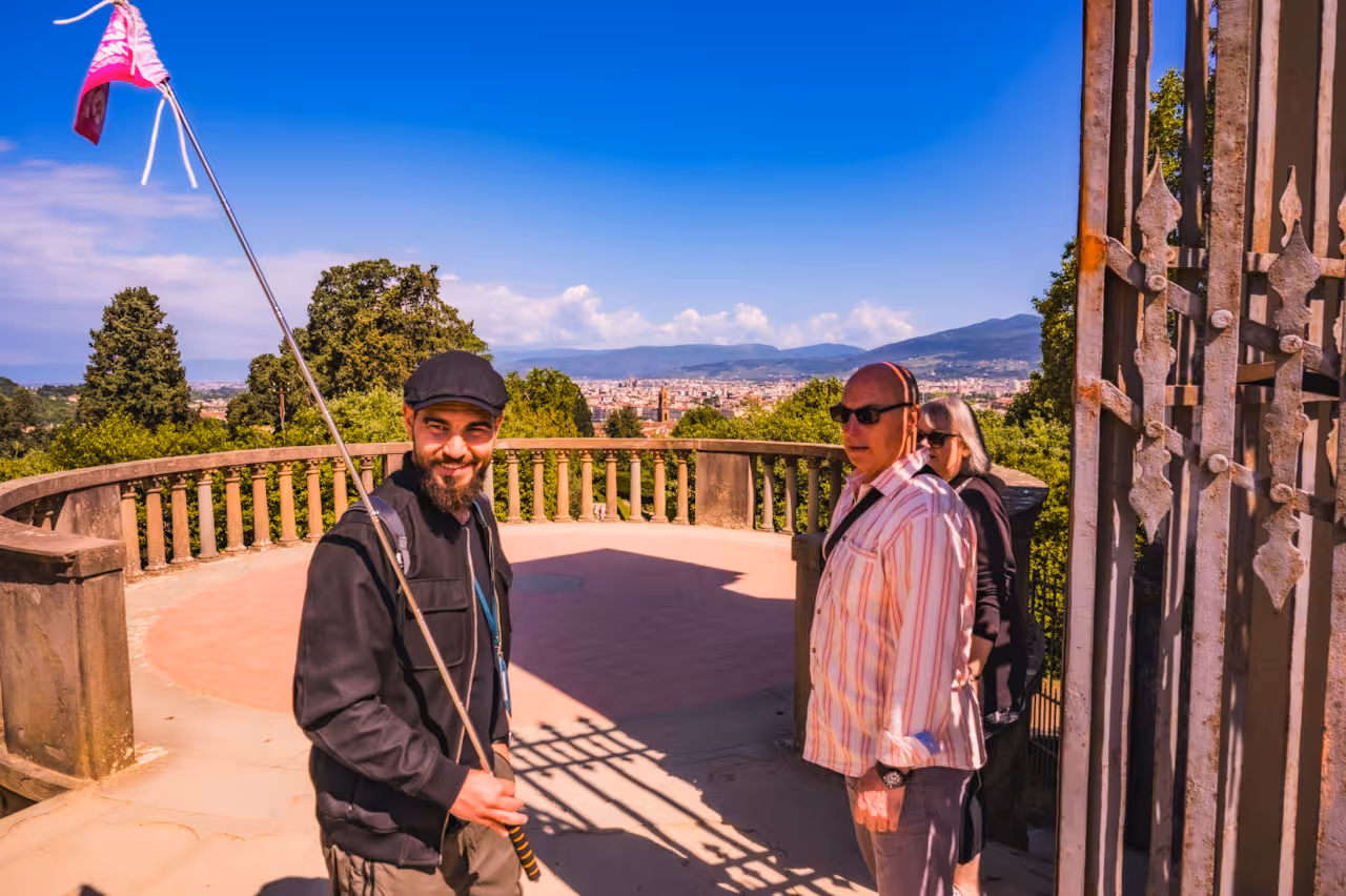 Tour guide with small group enjoying panoramic views over Florence from Boboli Gardens.