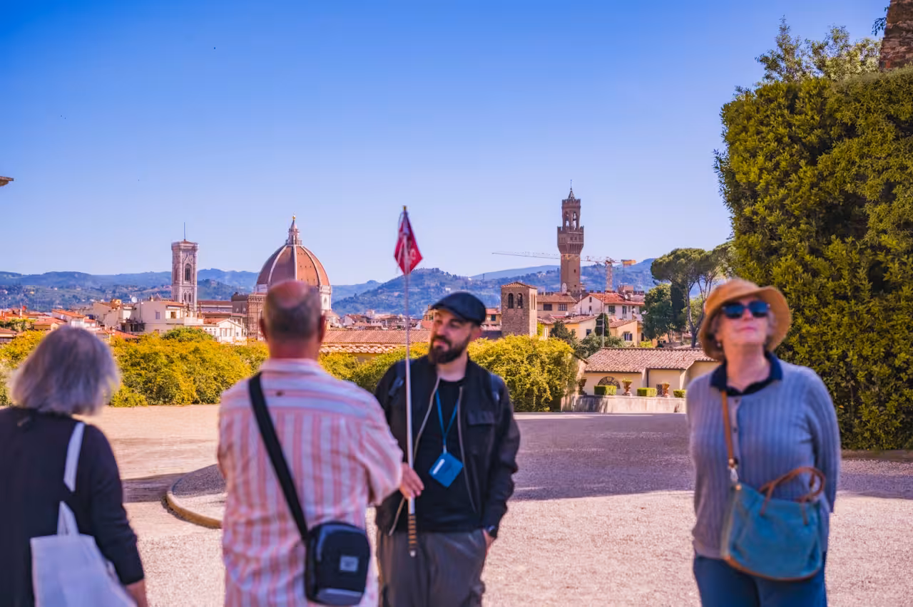 Tourists enjoying a scenic view of Florence's skyline from the Boboli Gardens.