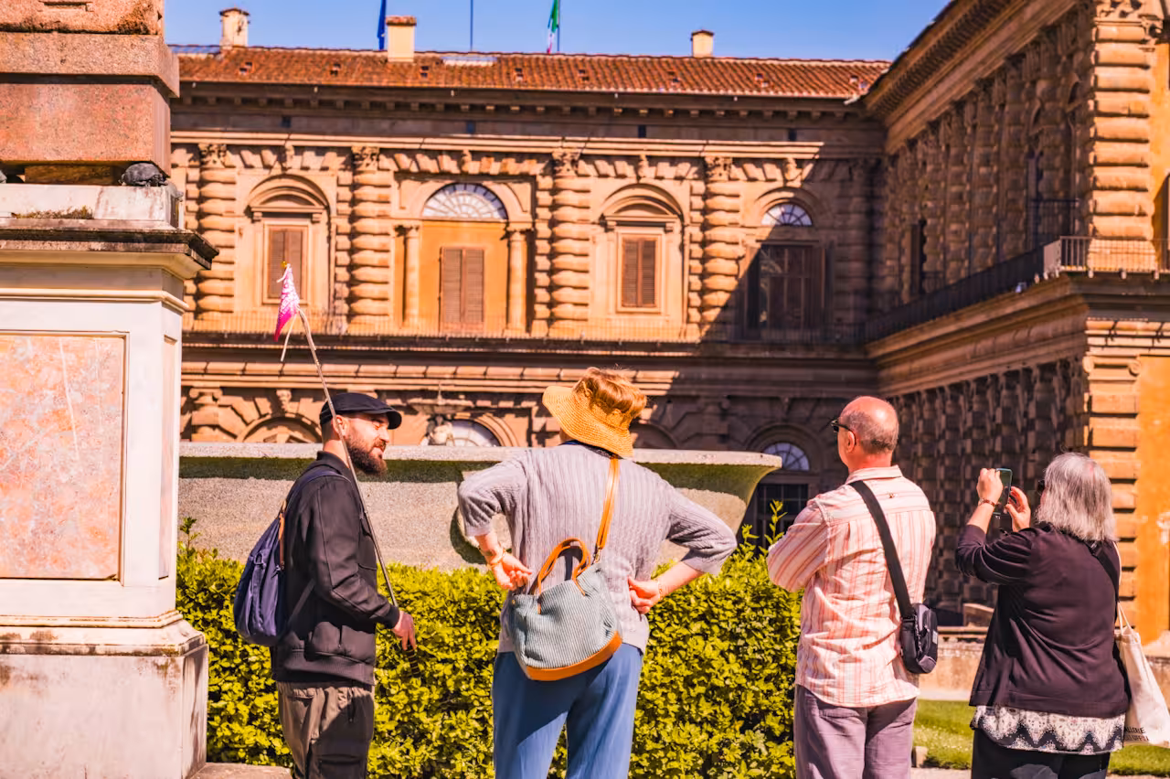 Tour group admiring the architectural beauty of Pitti Palace in Florence during a small group tour.
