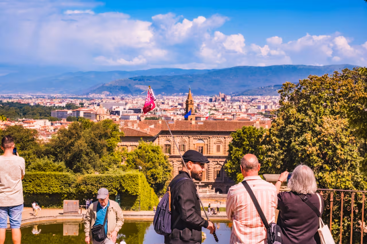 Visitors at Boboli Gardens overlooking Florence cityscape, highlighting the historic beauty of Pitti Palace.