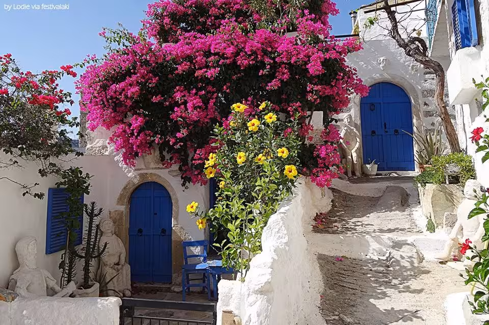 Plaka alley with bougainvillea and blue doors, charming photo stop on Anastasia’s private Athens walking food tour