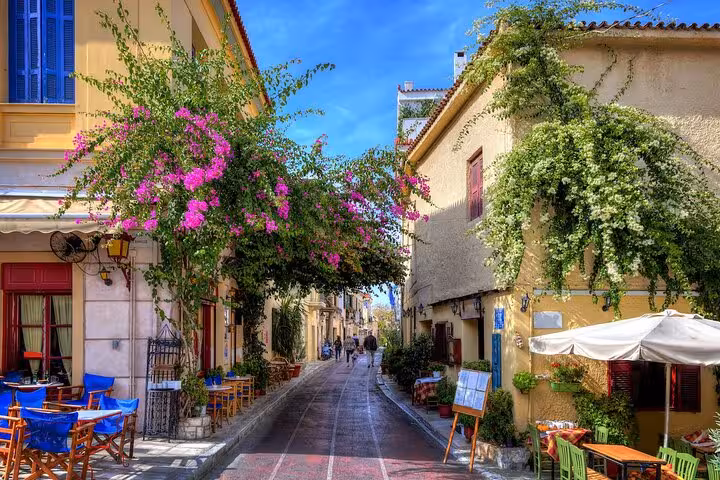 Charming Plaka street in Athens with cafes and bougainvillea, stop on Best of Athens private tour