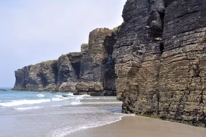 Stunning coastal cliffs and sandy shores of Playa de las Catedrales, featured on the North Spain & Portugal tour.