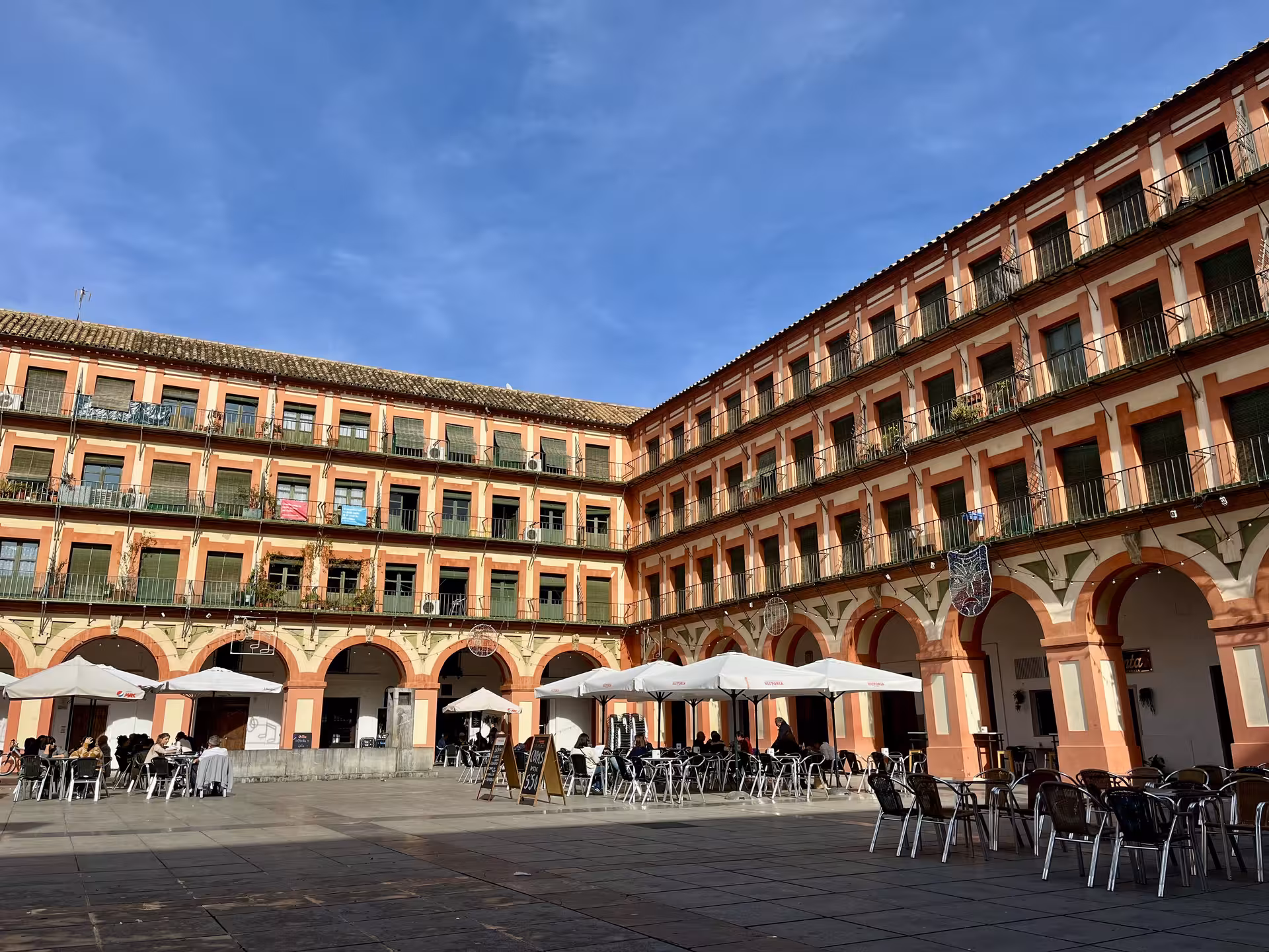 Plaza de la Corredera in Córdoba on Misterios Locales tour, arcaded square with cafés and historic balconies
