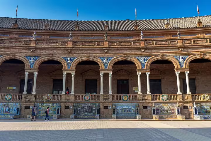 Exterior of Plaza de España in Seville, showcasing its ornate arches and vibrant tiles, a highlight of the Seville & Alcazar tour.