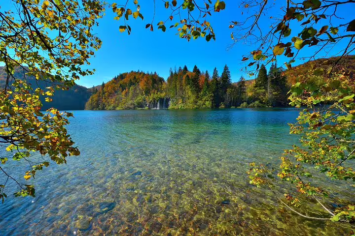 Plitvice Lakes National Park admission ticket panorama of a clear turquoise lake framed by autumn trees