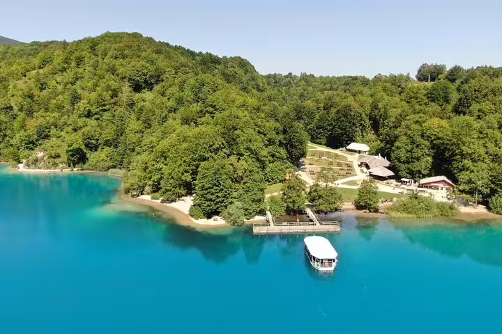 Plitvice Lakes boat pier and turquoise water surrounded by forest, Croatia National Park admission ticket