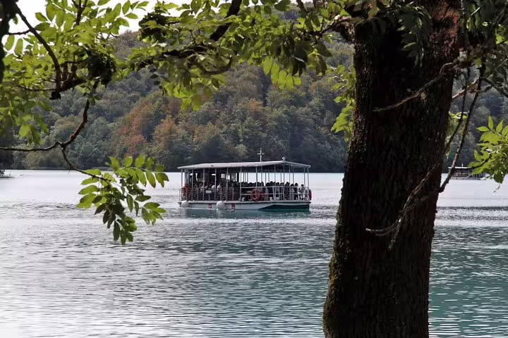 Electric boat crossing Plitvice Lakes on guided group tour from Split, Croatia national park scenery