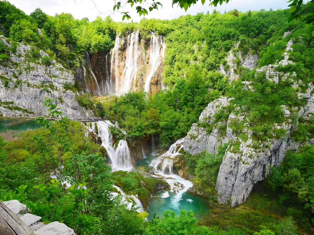 Plitvice Lakes guided group tour view of Veliki Slap waterfall and turquoise pools in lush Croatia