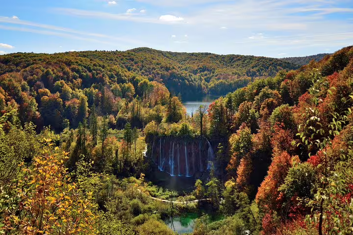 Panoramic view of Plitvice Lakes National Park waterfalls and autumn forest, Croatia entry ticket experience