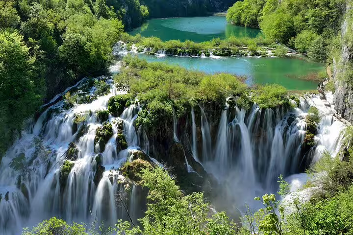 Waterfalls and turquoise lakes at Plitvice Lakes National Park, Croatia, scenic view with admission ticket