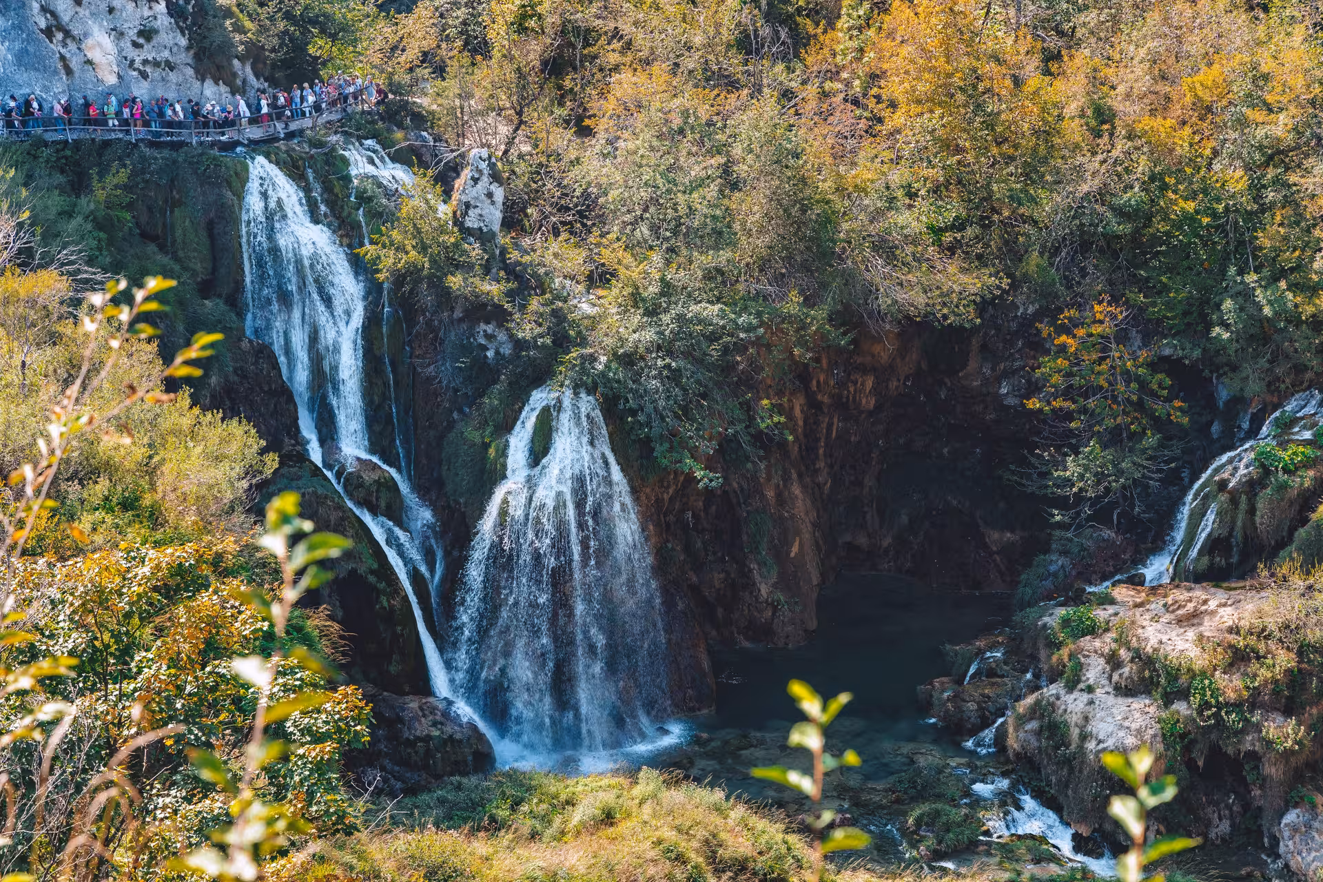 Waterfalls and boardwalk crowd at Plitvice Lakes National Park on a full-day guided tour from Split, Croatia