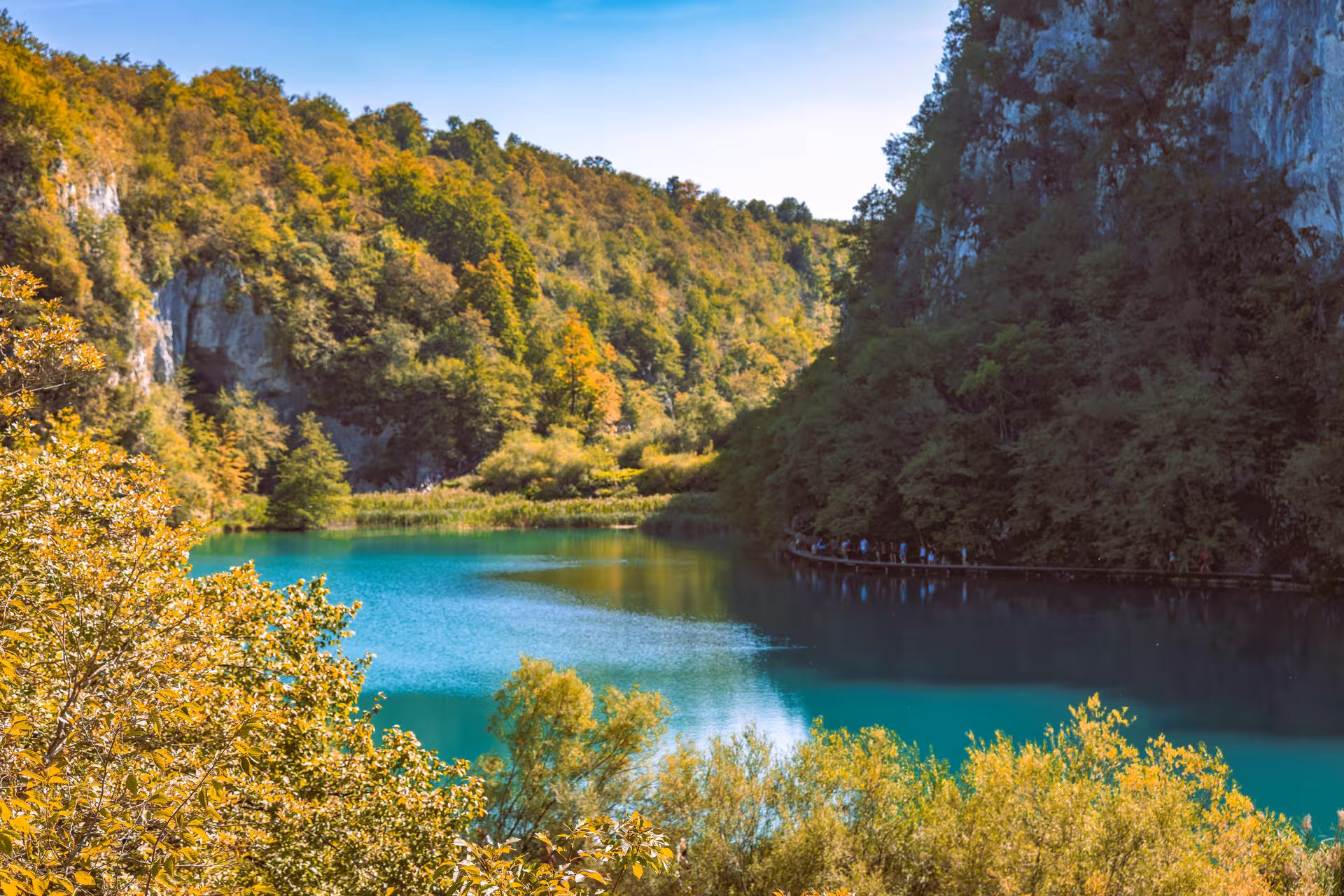 Turquoise lake and forested cliffs in Plitvice Lakes National Park on a scenic day trip from Zadar