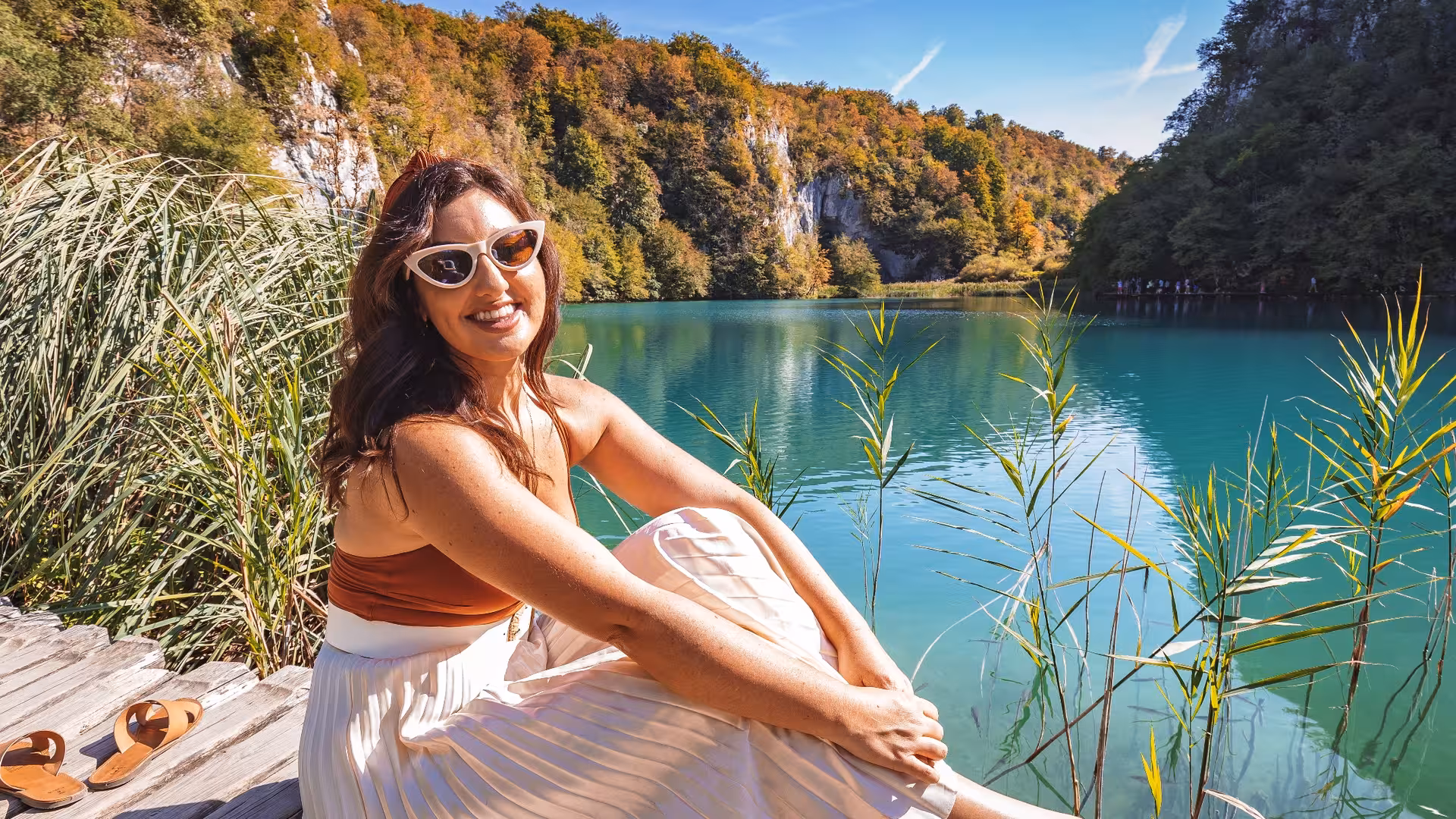 Traveler relaxing by a turquoise lake in Plitvice Lakes National Park on a day trip tour from Split, Croatia