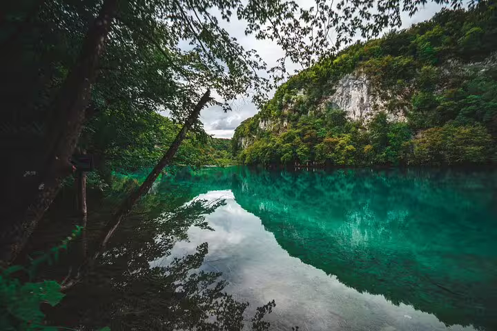 Turquoise lake and forest cliffs in Plitvice Lakes National Park on a private guided tour in Croatia