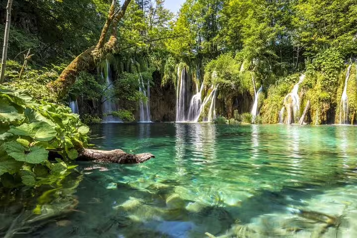Turquoise lake and cascading waterfalls in Plitvice Lakes National Park on a private tour from Split, Croatia