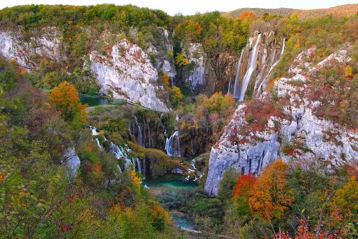 Dramatic Plitvice Lakes National Park waterfall and emerald pools among limestone cliffs, Croatia admission
