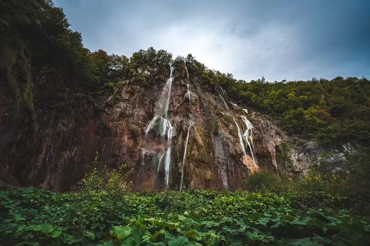 Waterfall cascading down limestone cliffs at Plitvice Lakes on a private guided tour in Croatia