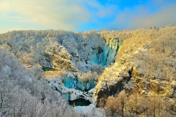 Winter panorama of Plitvice Lakes National Park with frozen waterfalls and snowy forest, Croatia entry ticket