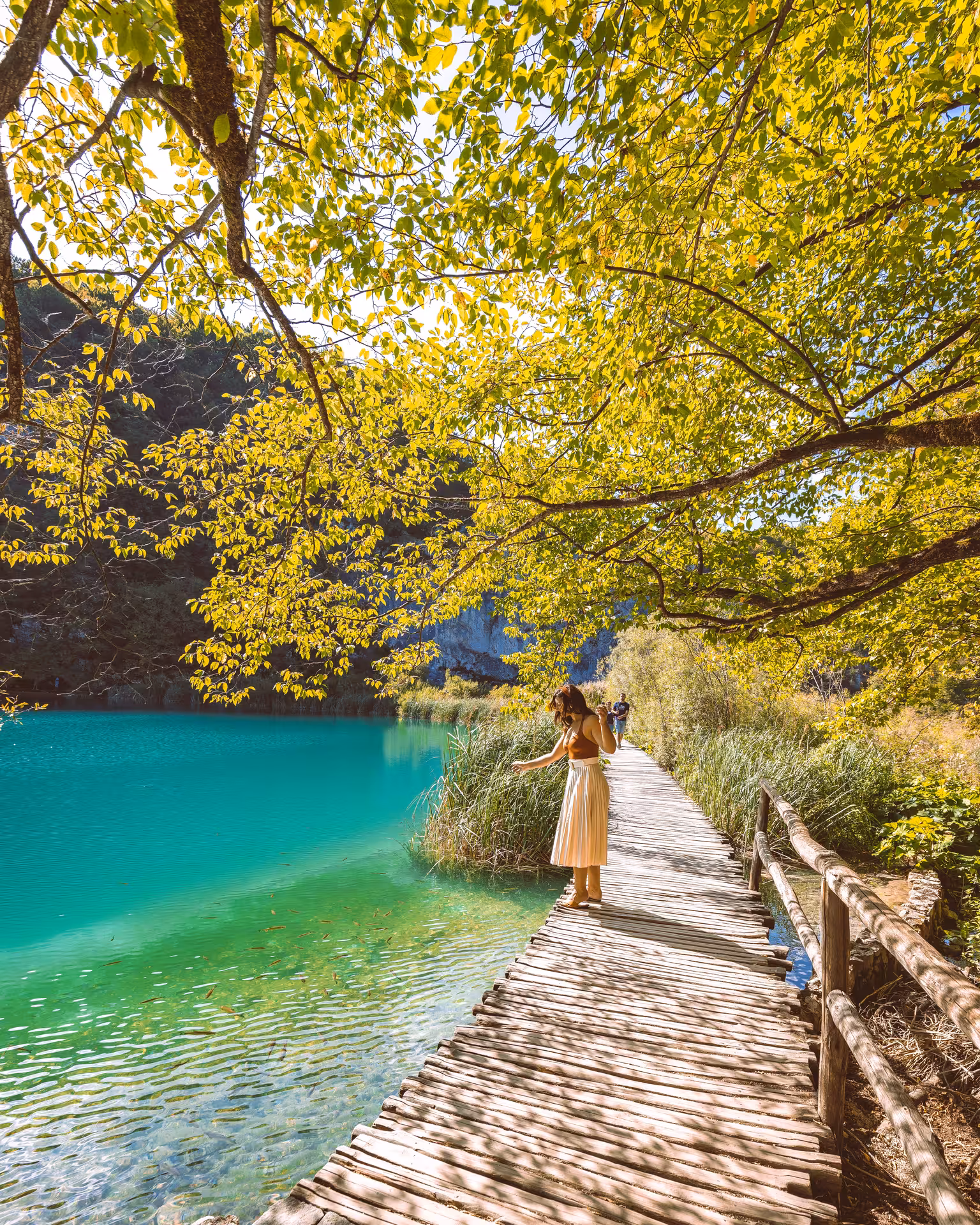 Wooden boardwalk beside emerald waters at Plitvice Lakes National Park, a popular Zadar day tour stop