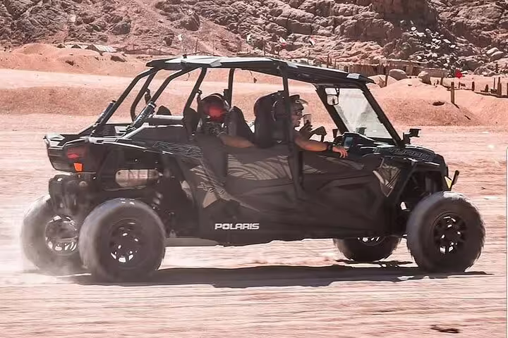 Polaris side-by-side racing across Sinai sand on a double buggy adventure desert safari tour from Sharm El Sheikh