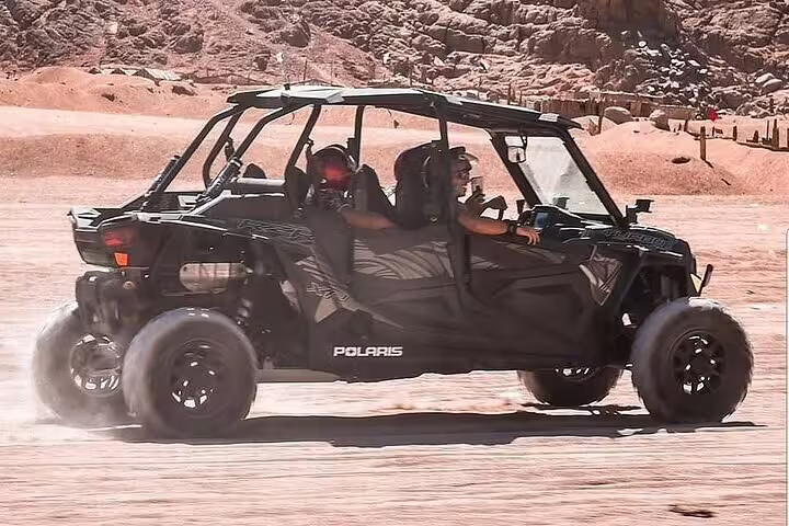 Polaris family buggy racing on Sinai desert track, Sharm El Sheikh buggy safari tour with dust trail