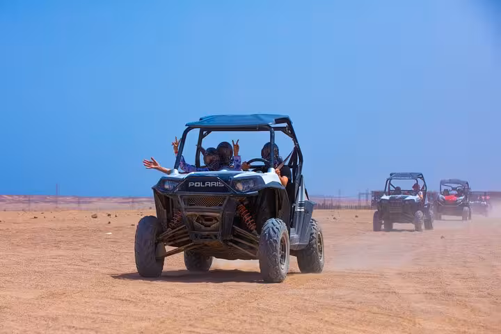 Polaris spider car buggy driving in the desert during Viva Safari quad adventure with dinner and show