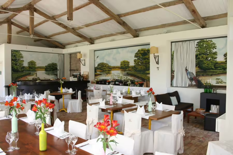 Charming country-style restaurant near Altomonte with rustic beams, floral decor and views of Pollino National Park