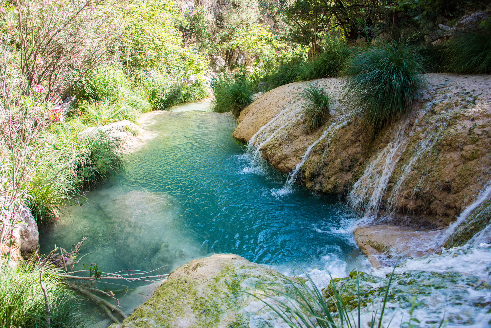 Turquoise pool and small cascades on the Polylimnio Waterfalls hiking trail in Messinia, Peloponnese Greece