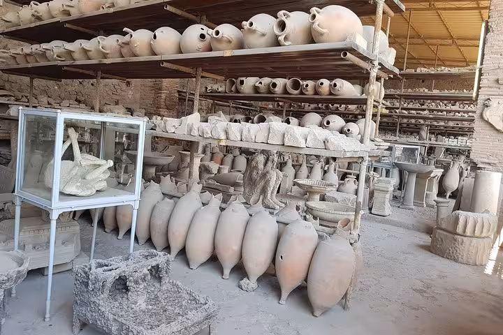 Pompeii artifact storage with amphorae and relics, guided visit on 6-day private tour from Rome to Capri