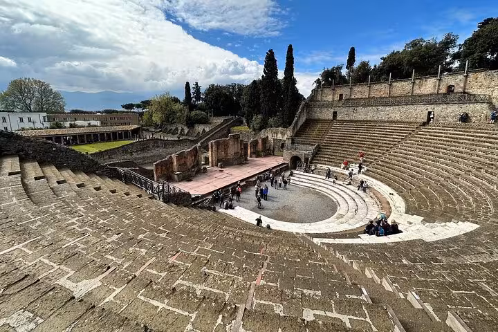 Scenic view of the ancient amphitheater in Pompeii, perfect for a guided tour with lunch from Sorrento.