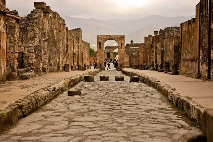Ancient cobblestone street in Pompeii on a private day tour from Naples with Vesuvius and Herculaneum